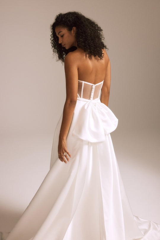 NouvelleAmsale_Bridal_LINCOLN_R451S_DuchessSatin_SheerBack_A-LineGown_IllusionPlunge_Cutaway_BowDetail_Mood2_540x.jpg